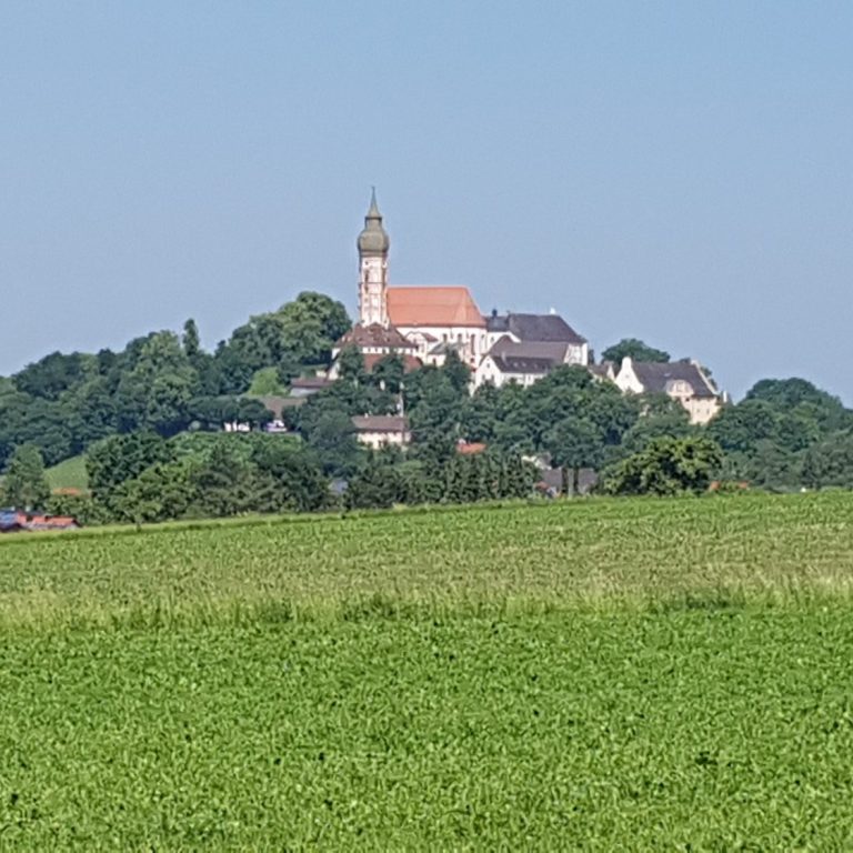 Eberhofer Kreisel Zwei lebensgroße Figuren stehen für den "Franz-Eberhofer-Kreisverkehr" in einer Landschaft.